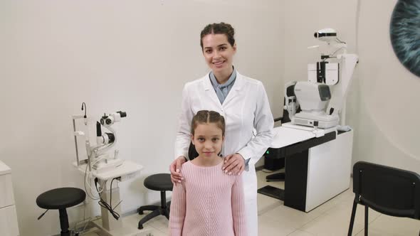 Portrait Of Female Oculist With Little Patient