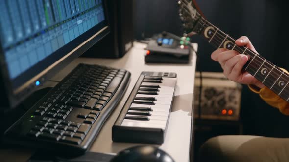 Close Up Male Hands of Musician Recording Song in Record Studio