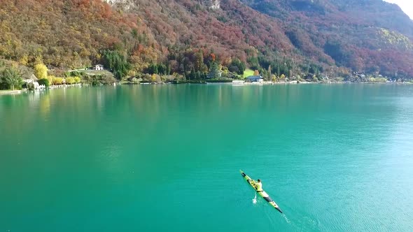 A kayaker paddles in a scenic mountain lake.