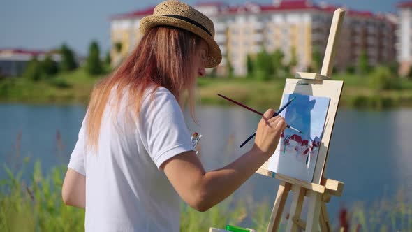 Woman is Drawing Cityscape in Park in Summer Day Beginning Artist is Working Outdoors