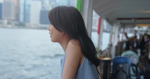 Woman visit Hong Kong city and take the ferry 