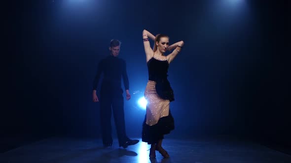 Latinamerican Dancing Pair of Professional Elegant Dancers in Smoky Studio