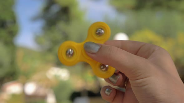 Woman relaxing with spinner fidget / Videohive