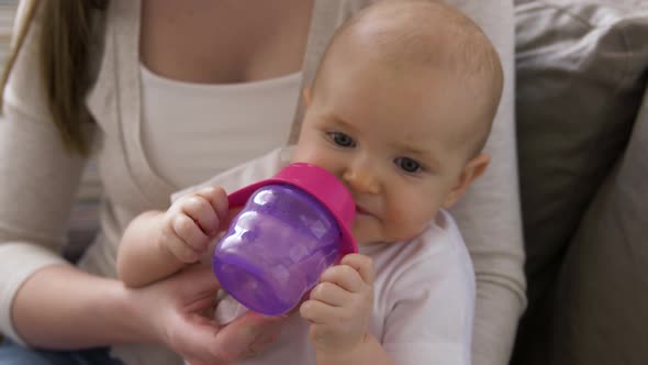 Close Up of Mother with Baby Drinking Water