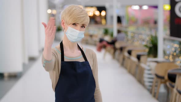 Friendly Caucasian Masked Woman Female Waitress in Medical Face Protective Mask Restaurant Cafe