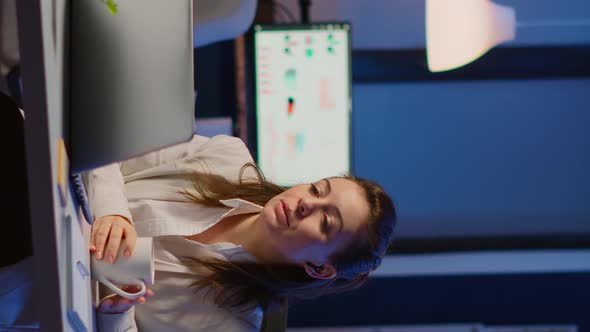 Vertical Video Manager Speaking Online with Remotely Coworkers Late at Night