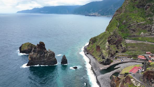 Aerial over rugged lava rock formations on coast, Porto Moniz, Madeira