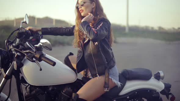 Pretty Female Biker Sitting on the Motorcycle Seat