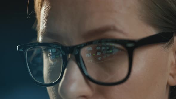 Woman in Glasses Looking on the Monitor and Working with Data and Analytics
