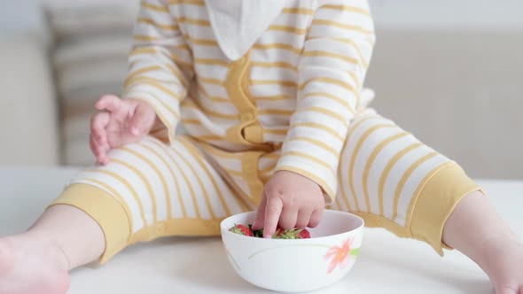 Portrait Eating Baby at Home