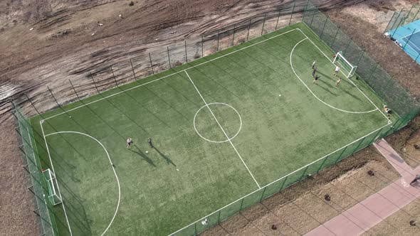Boys playing soccer, training on football field. 