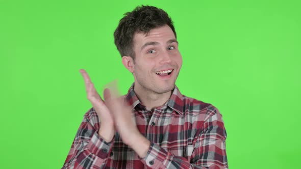 Portrait of Young Man Clapping Applauding Green Chroma Screen