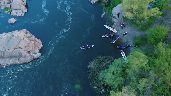 A Topdown Aerial View of Rowers on Kayak Docking to the Coast