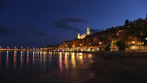 Menton by night from the beach. Cote d'Azur in Provence, France. Mediterranean sea. Saint Michel Bas