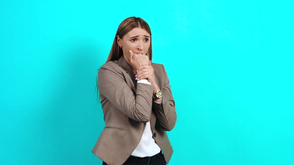 Frightened Adult Woman in a Business Suit, Closing Her Eyes and Reaching Out