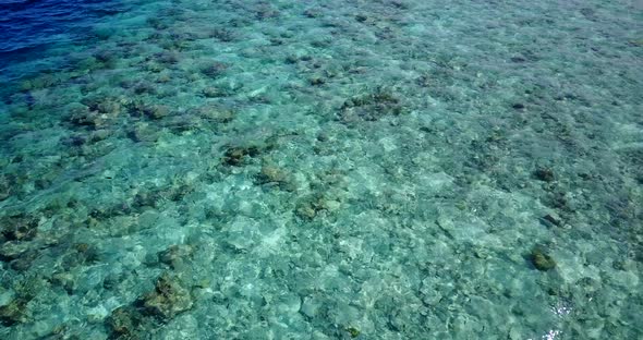 Daytime above abstract shot of a paradise sunny white sand beach and aqua turquoise water background