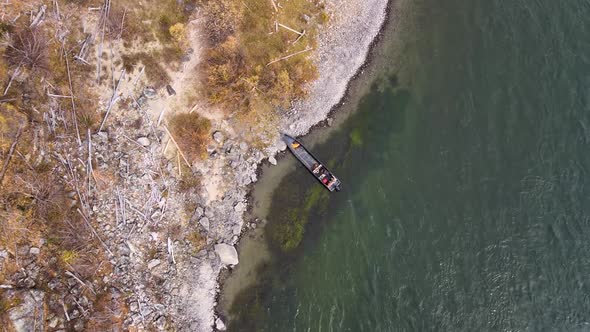 Top View of the Coast of a Stormy Mountain River Rocky Coast Coniferous Forest Clear Water the Boat