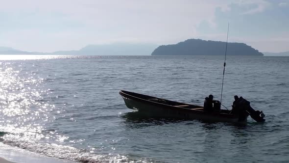 A Small Motor Boat Drifting In Solomon Islands With Tropical Island In The Background