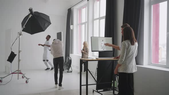 Art Director Checking the Photos on a Monitor