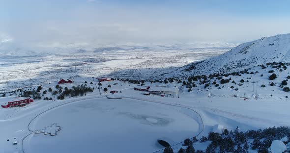 Snowy Mountains Ski Center And Skiers Aerial View