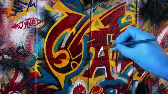 Man Painting Graffiti Art On Wall