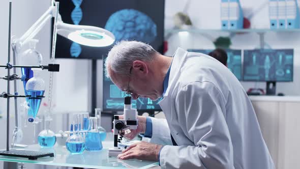 In Modern Laboratory Scientist Is Looking at Samples Through a Microscope alt
