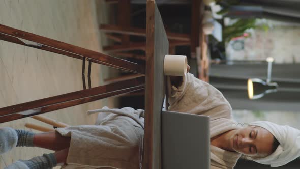 Woman in Bathrobe Using Laptop at Home