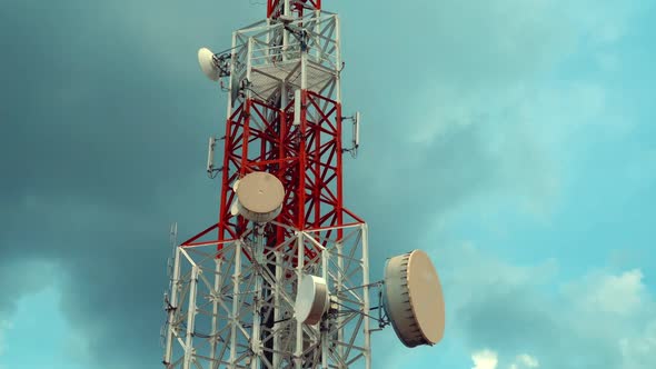 Large Telecommunication Tower Against Sky and Clouds in Background