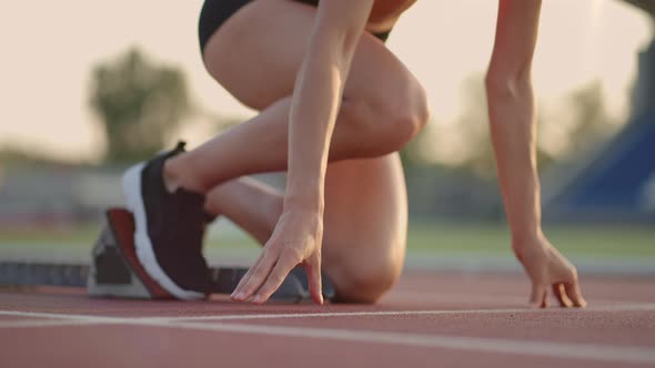 Caucasian Young Brunette Woman Shit for a Run in the Stadium Comes Up to the Running Sides and