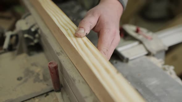 Male Carpenter Working with Planing Machine in Workshop