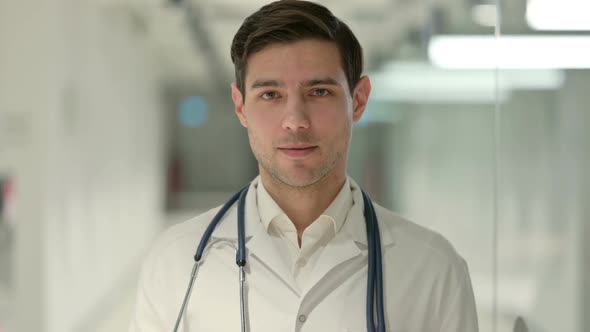 Portrait of Male Doctor Talking on Video Call