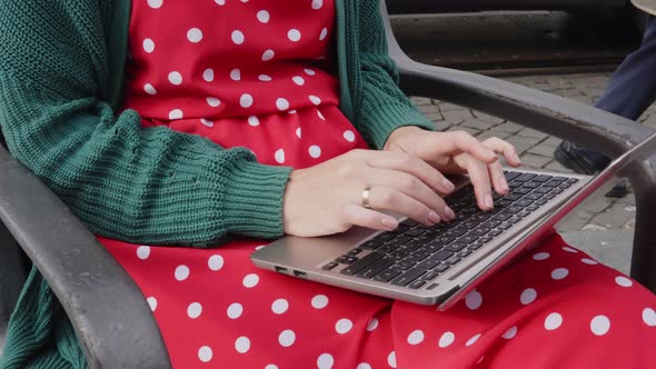 Woman Freelancer Is Working at Laptop in City