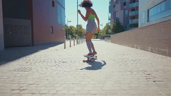 Beautiful young woman cruising around the city with her longboard.