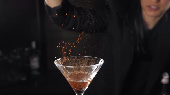 Bartender Sets Fire To Cocktail, Burning Cinnamon in Alcohol Drink on Black Background. Flames in