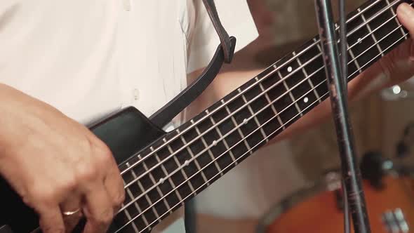 Guitarist Plays the Guitar As Part of a Band at a Concert