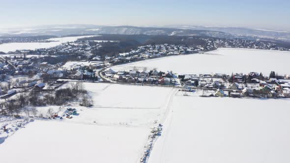 Aerial Drone Shot  Snowcovered Villages Fields and Forests in a Rural Area in Winter