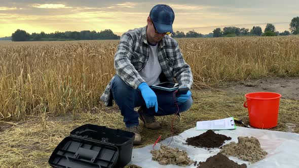 Agronomist Preparing Soil Measurements Digital Device at Field Dawn