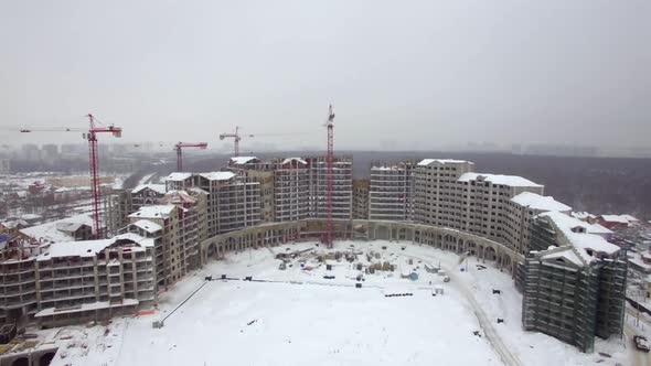 An Aerial View of a Multi Storey Building Construction in the Snow