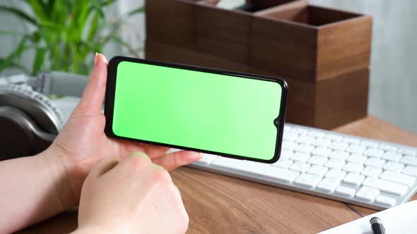 Womans Hands Scrolling Smartphone Screen