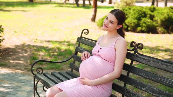 A Pregnant Girl is Sitting on a Park Bench and Her Stomach Begins to Hurt and She Begins to Breathe