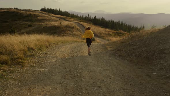 Active Woman Running in Mountains