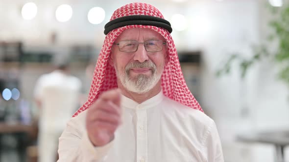 Senior Old Arab Businessman with Pointing and Inviting