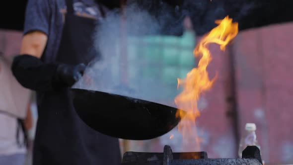 Street Food. Chef Cooking Thai Meal In Wok On Fire Outdoors
