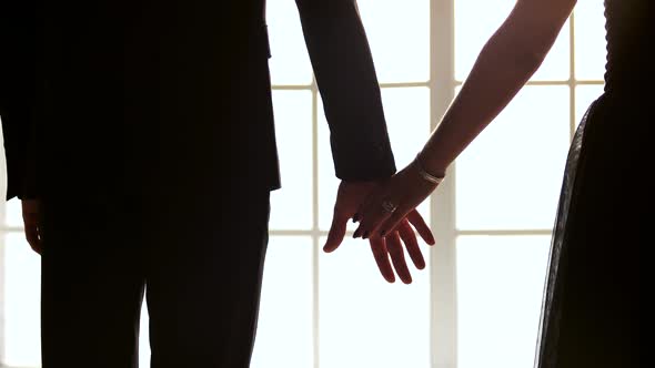 Close Up Young Couple Joining Hands Together Indoors