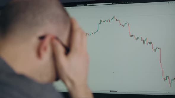 A Trader in Depression Due to a Fall in the Stock Market or Crypto Currency