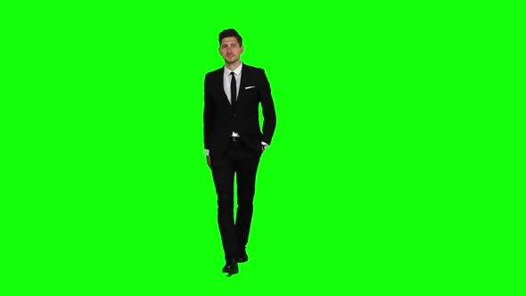 Businessman Is Going To a Meeting and Waving Greetings. Green Screen