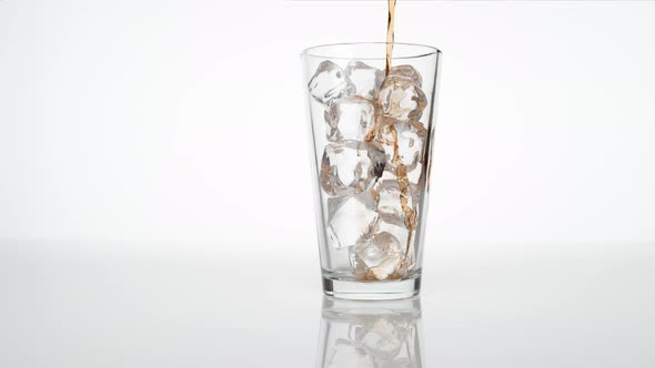 Pouring soda into glass. Slow Motion.