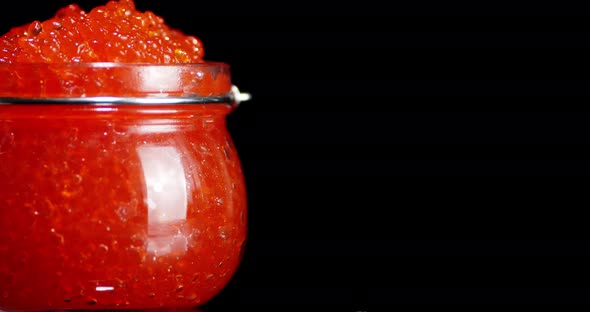 A Full Jar of Delicious Red Caviar Slowly Rotates. 