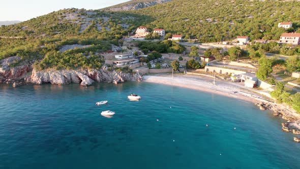 Aerial View of the Rocky Coast of Croatia with Camping and Curve Road at Sunset