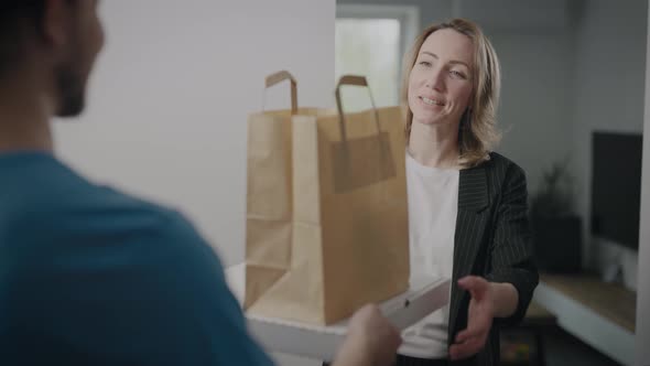 A Delivery Man in a Blue Uniform Brought an Order